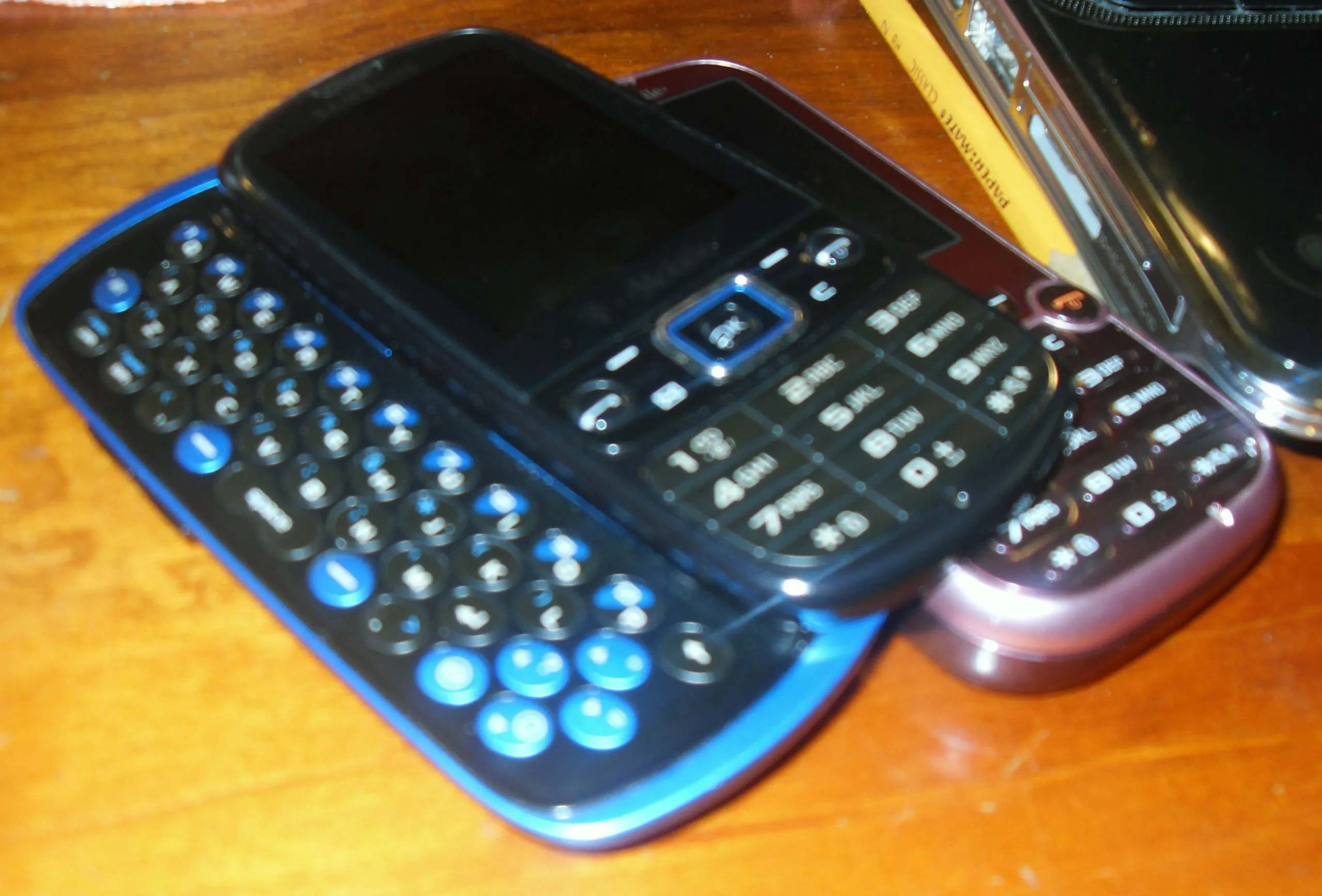 Blurry photograph from 2011 of two Samsung Gravity 2 phones.